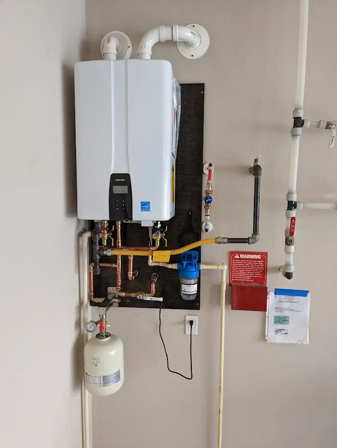 Professional plumber installing copper piping in a Whitefish Bay home